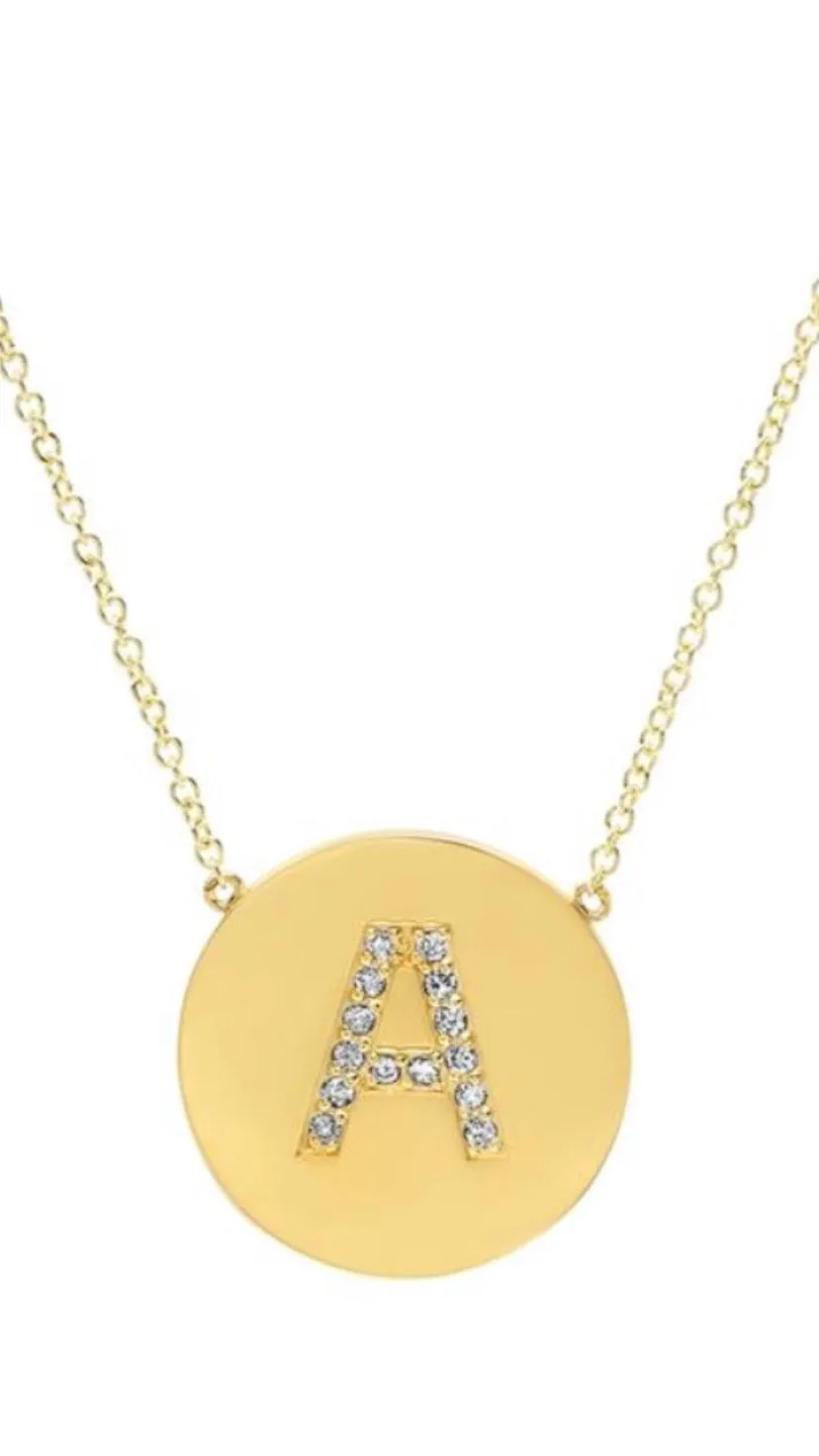 Diamond letter set in 14k matte gold disk necklace